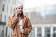 © Miquel - Businesswoman talking on smartphone while walking in urban city