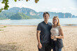 © Allison - Couple enjoys a sunny day at the beach near tropical mountain