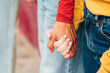 © ADDICTIVE STOCK - A close-up of teen girls holding hands