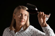 © New Africa - Professional sommelier analyzing quality of red wine on black background, selective focus