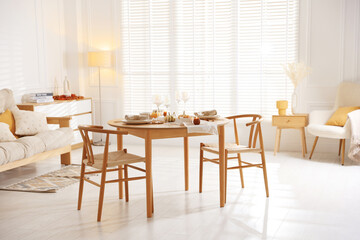 Poster - Stylish table setting with beautiful dishware and autumn decor in dining room