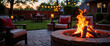 © Yury - Cozy backyard with a crackling fire pit illuminating comfortable seating area at dusk, creating a warm and inviting atmosphere for gatherings