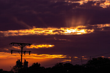 Wall Mural - silhouette of electric pole and power line with beautiful sunset background