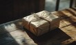 © Александр Михайлюк - A wrapped package with twine on a wooden table, sunlight.