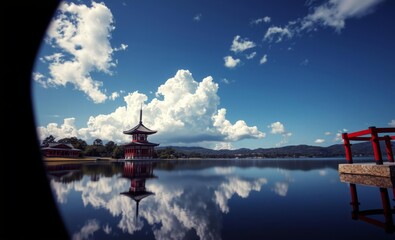 Breathtaking view of a traditional red japanese pagoda structure reflected in a serene pond set against a backdrop of a blue sky with fluffy white clouds East Asian china japan japanese asian korea ko