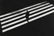 © talkative.studio - Person walking pedestrian crossing, black and white, urban scene. Possible use Stock photo for book cover, poster