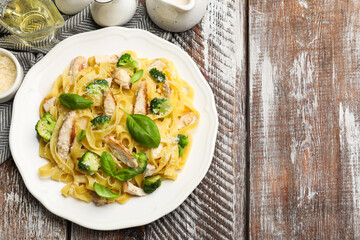 Sticker - Delicious pasta Alfredo with chicken served on wooden table, flat lay. Space for text