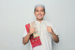 © Terang Bulan Gallery - Asian muslim man gives a spirited gesture and looks at the camera.