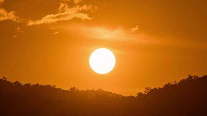 Wall Mural - breathtaking beauty of the sun rising time lapse video over a rugged mountain ridge on a cloudy morn