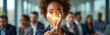 © Vadym - Business woman holding glowing light bulb. Diverse people in background during business meeting, brainstorm. Concept of innovation, idea creation, collaboration, inspiration, teamwork and creativity.