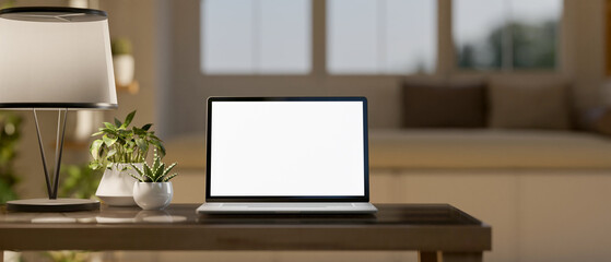 Wall Mural - a close up of white screen laptop on the wooden table with decorative item in the living room.