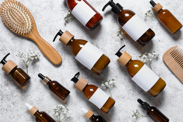 Wall Mural - Composition with bottles of shampoo, hair brush and gypsophila flowers on white grunge background