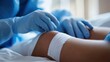© Ari - Close-up of a Doctor Applying a Bandage on a Patient's Knee in a Hospital Setting
