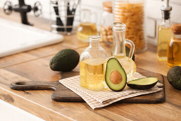 Canvas Print - Bottle and jug of fresh avocado oil on kitchen counter