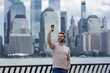 © Volodymyr - Mature Man talking at the phone in New York City. Man talking on the phone on NY. Male model in t-shirt talking on cell phone. Guy talking by mobile phone. Tourist in city street holding smartphone.
