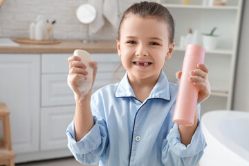 Wall Mural - Cute little girl with soap bar and shower gel in bathroom