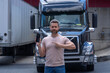 © Volodymyr - Truck driver. CDL. Portrait of trucker standing by his truck vehicle ready for transport. Male driver standing in front on his truck.
