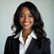 © Javier - Confident young woman in a business suit with a bright smile.