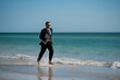 © Volodymyr - Excited summer business travel. Freelance work, online working. Summer businessman in suit run in sea water. Freelance travel. Funny freelancer in suit jump and run in the sea. Freelance and holidays.