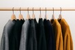 © Assyarifah - Assortment of knitted sweaters on hangers display wardrobe collection
