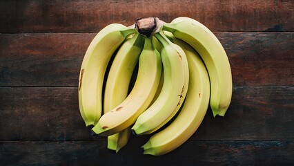 Wall Mural - Cluster of ripe yellow bananas atop a rustic wooden surface with a warm brown texture showcasing their natural beauty and freshness