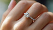 © PACHARA - A woman is holding a diamond ring
