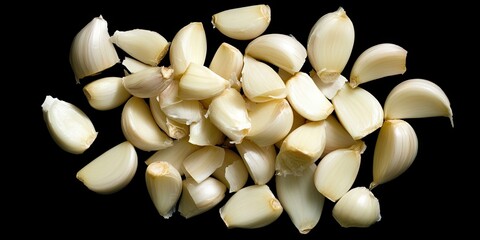 Poster - peeled garlic cloves arranged in a dynamic pile on a black background showcasing varied sizes and te