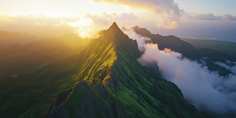 Leinwandbilder - Sunrise over lush green mountain peaks with dramatic cloud formations in the sky, highlighting vibrant shades of green and golden sunlight.
