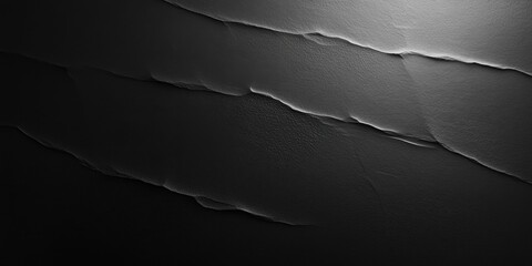 Poster - textured black paper background showcasing subtle creases and a soft spotlight effect creating an el