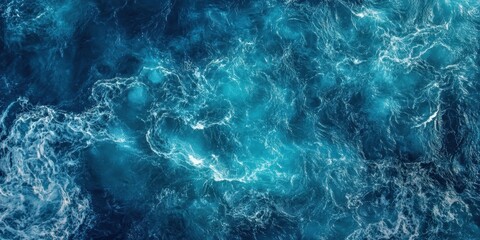 Poster - Aerial view of deep blue ocean water with captivating turquoise patterns and white foam accents creating dynamic textures and movement in the sea.