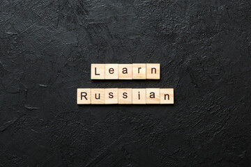 Wall Mural - learn russian word written on wood block. learn russian text on table, concept