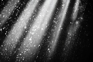 Poster - dramatic monochrome image of falling water droplets with a stark contrast against a dark background,