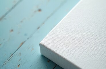 Poster - Close-up shot shows corner of white canvas stretched on wooden stretcher bar on the turquoise wooden table. Art blank for painting mock-up. Gallery wrapped canvas.