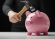 © Purnama Alam - Breaking Piggy Bank with Hammer Representing Financial Crisis or Savings