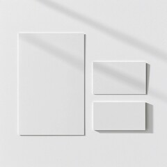 Poster - Minimalist stationery mockup featuring a letterhead and two business cards, subtly shaded by soft window light on a textured white wall, ideal for branding.
