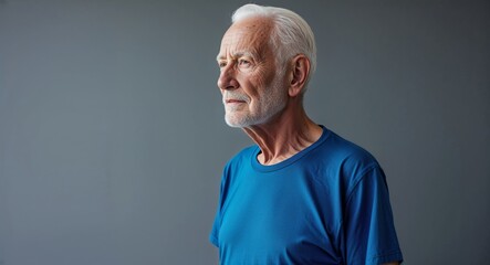 Canvas Print - Elderly Caucasian man in plain gray background blue t shirt side view portrait