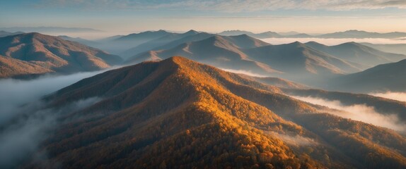 Canvas Print - Aerial View of Autumn Mountains with Mist and Soft Light Creating a Serene Landscape in the Morning Hours.