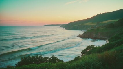 Wall Mural - Tranquil Coastal Landscape at Sunset Featuring Gentle Waves and Lush Green Hillside Under Soft Colorful Skies