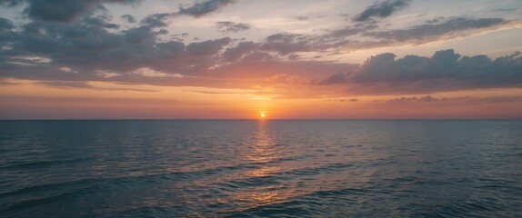 Wall Mural - Tranquil Ocean Sunset with Reflective Water and Dramatic Cloudscape in the Background