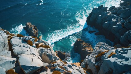 Poster - aerial view of rocky coastline with turquoise sea waves and clear copy space for text or design solu