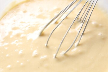 Wall Mural - Whisk and bowl of dough, closeup view