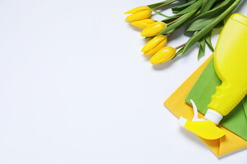 Wall Mural - Spring cleaning. Detergent, rags and tulips on white background, flat lay. Space for text