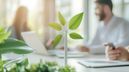 Aufkleber - small wind turbine model with green leaves on desk, symbolizing renewable energy