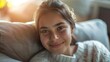 © Z A C - A young woman's smiling face as she relaxes in a home setting with natural light illuminating her profile.