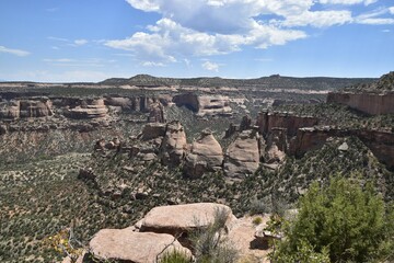 Wall Mural - Scenic view of Colorado National Monument with rugged cliffs and blue sky, showcasing natural beauty