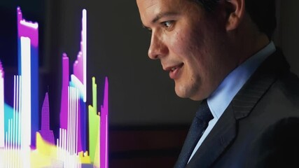 Poster - Businessman in suit analyzing glowing holographic charts of financial data in dark office, possibly discussing market trends and investment strategies