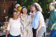 © Wavebreak Media - Diverse senior friends celebrating together outdoors, smiling and embracing at joyful gathering