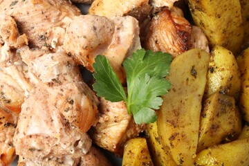 Wall Mural - Pieces of delicious baked turkey and potatoes as background, closeup