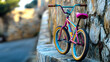 © Erika - una bicicleta colorida moderna recargada sobre una pared de piedra en la calle del pueblo o de la ciudad fondo urbano y llamativo por el camino