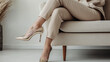 © Alina Tymofieieva - Elegant woman in gold heels seated in a modern living room showcasing contemporary fashion and design elements